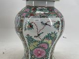a vase with a lid that has birds and flowers on it