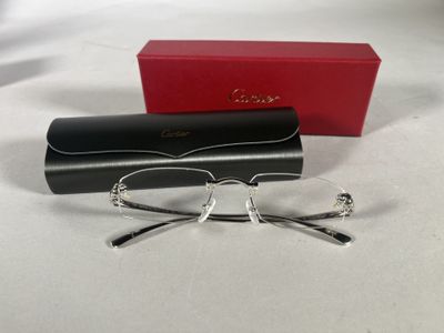 glasses are laying on a white surface next to a red box