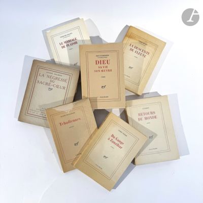 several books are stacked on top of each other on a white surface