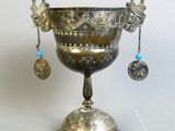 a silver cup that is sitting on top of a table