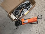 a box with a cord and a cord cutter in it
