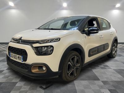 a white citrole is parked on a checkered floor