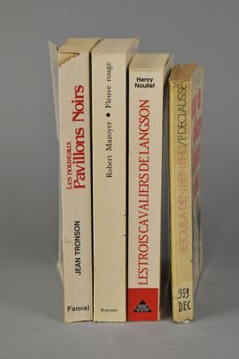 three books are stacked on top of each other on a table