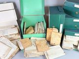 many boxes of old books and papers on a table