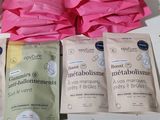 three bags of baby food sit on a table next to a bottle of milk