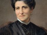 portrait of a woman in a black dress with a cross in her hair
