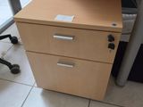 a desk with a file cabinet and a computer monitor on it