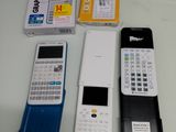 three cell phones sitting next to each other on a table