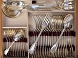 many spoons, forks and spoons in a wooden box