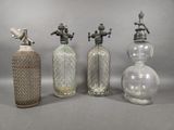 three antique glass bottles and a faucet on a gray background