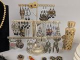 a display of jewelry on a table next to a purse