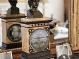 a picture of a clock with a bust of a man on top of it