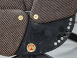 a close up of a brown chair with buttons on it