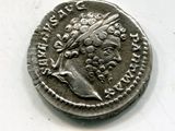 a silver coin with an image of a woman on it
