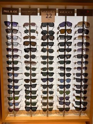 many pairs of sunglasses on display in a display case
