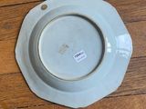 a plate with a sticker on it sitting on a table