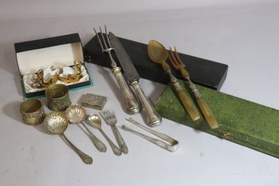 a lot of silverware on a table next to a box