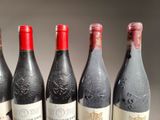 six bottles of wine are lined up in a row on a table