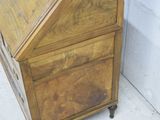 a small wooden desk with a drawer on top of it