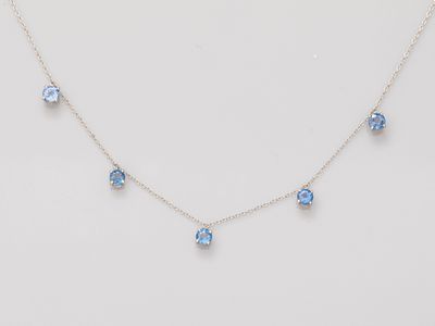 a necklace with blue crystals on a white background