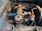 an old car engine with a lot of rust on it