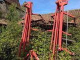 a red crane that is sitting in the grass