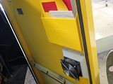 a yellow door with a red and white sign on it