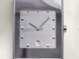 a close up of a watch on a white surface
