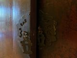 a close up of a metal door with a clock on it