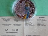 a silver coin with a picture of a woman on it