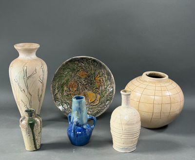 four vases and a bowl sitting on a table