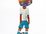 statue of a boy with a soccer ball on a black base