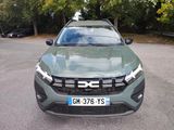 the front view of a green suv parked in a parking lot