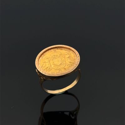 an image of a gold ring with a coin in the middle