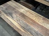a close up of a wooden table with a tray of muffins on it