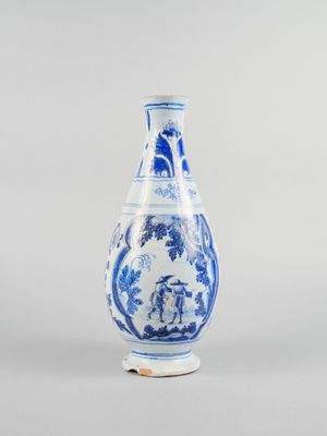 blue and white vase with figures on a stand on a gray background