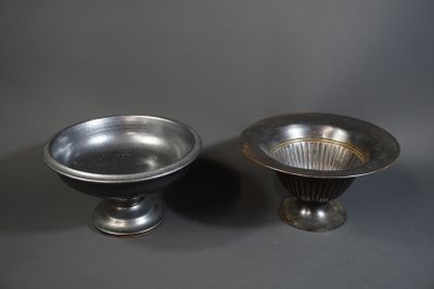 pair of silver plated bowls on pedestals against a gray background