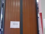 a large wooden cabinet in the middle of a warehouse