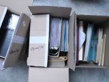 a cardboard box filled with files and papers on the floor