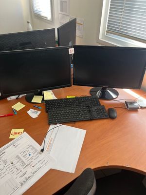 un bureau sur lequel sont posés deux écrans d'ordinateur et un clavier