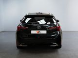 the back of a black toyota c - hr parked in a white room