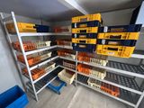 many crates and bins on the shelves in the room