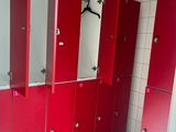 a row of red lockers in a public bathroom