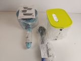 a plastic container with a toothbrush, toothpaste, and other items on a table