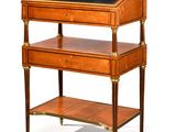 an antique writing desk with a black top and gold trimmings