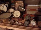 many different types of clocks on display in a glass case