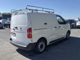 the back of a white van is parked in a parking lot