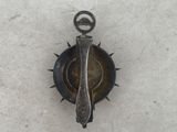 a small metal object that is sitting on the snow
