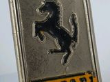 a close up of a ferrari badge on a white surface