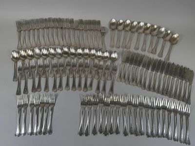many forks and spoons laid out on a table